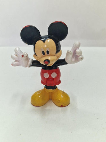 Figura Pvc: Mickey Mouse con los brazos en cruz (algo descolorida).Las articulaciones de las piernas son movibles)