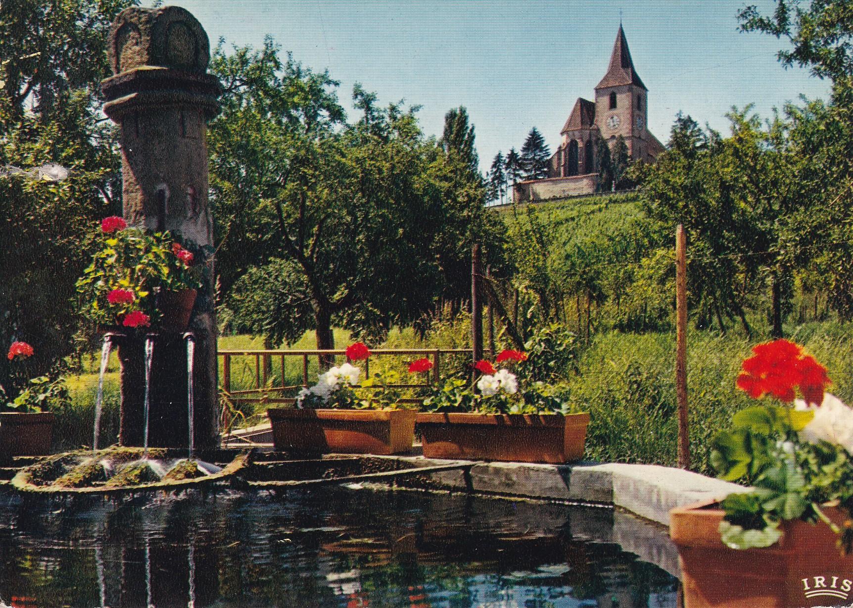 POSTAL 18183: La fontaine de Ste-Huna et l Eglise fortifiee de Hunawirh