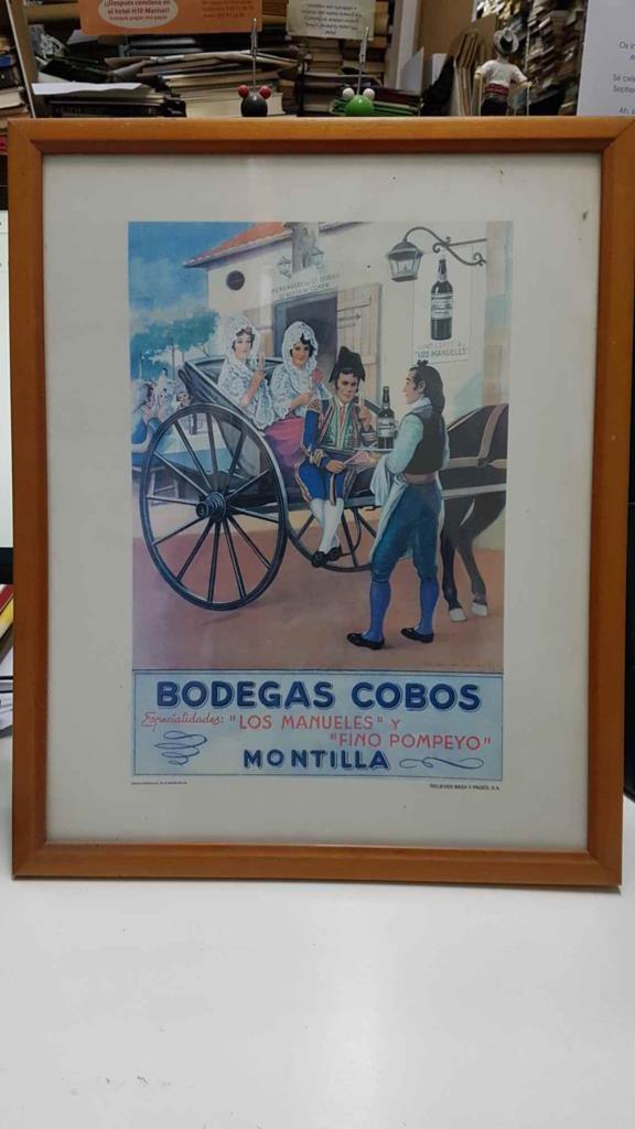 Cartel publicitario: enmarcado de Bodegas Cobos (Montilla). Especialidades: "Los Manueles" y "Fino Pompeyo", Montilla. Relieves Basa y Pagés.